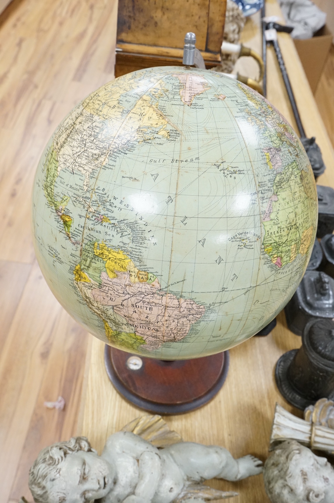 A vintage revolving globe with inset compass to the base, 55cm high